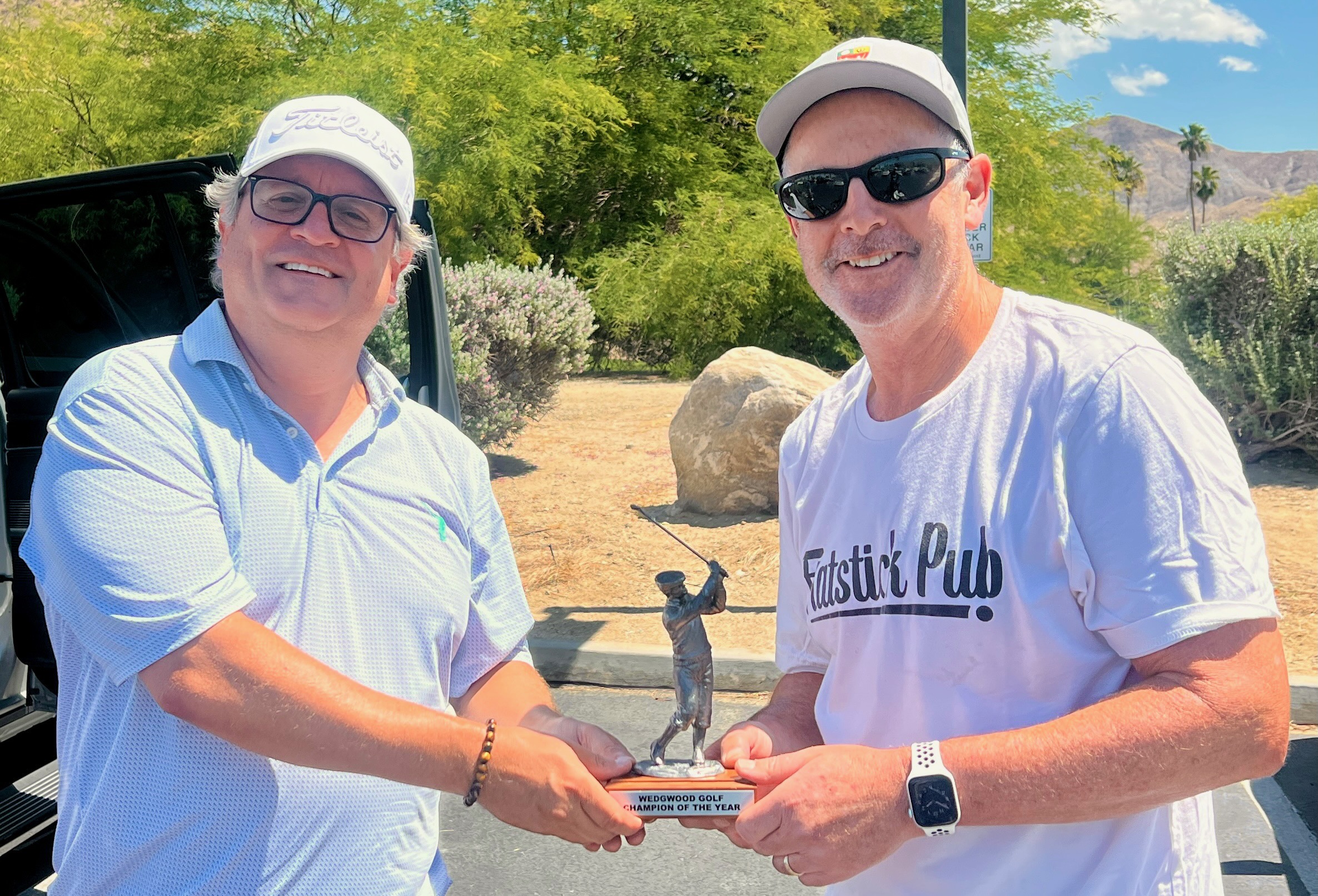 Cake passes the Wedghood trophy to Langley